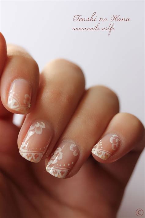 A Woman S Hand With French Manies And White Flowers On It While She Has