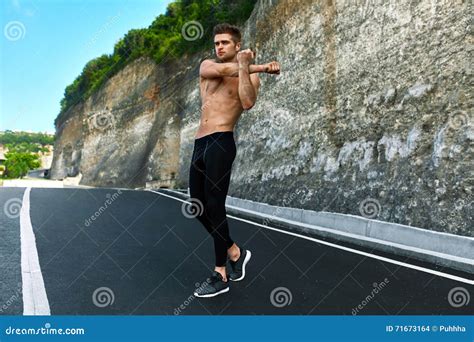 Fitness Man Stretching Body Exercising Before Running Outdoor Stock