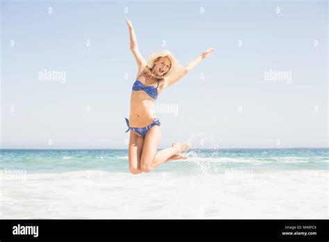 Carefree Woman In Bikini Jumping On The Beach Stock Photo Alamy