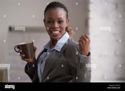 Candid Image Of A Businesswoman Drinking Coffee While Working At Office