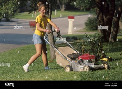 Teen girl using lawn mower hi-res stock photography and images - Alamy