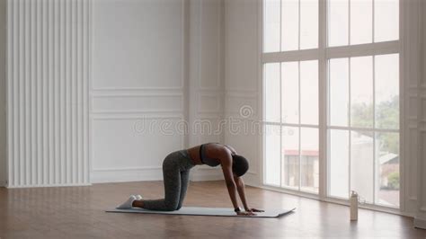 Flexible Black Woman Stretching Muscle Practicing Gymnastics In Morning