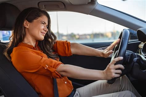 Premium Photo Happy Woman Driving A Car And Smiling Cute Young