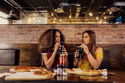 Best Friends Drinking Cola At Restaurant Jacob Lund Photography Store