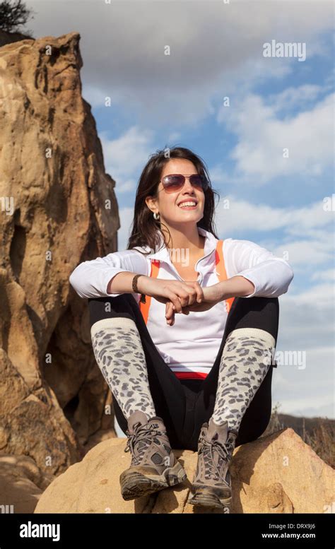 Hiker Relaxes On Rock Formation Above The Temescal Ridge Trail Reached