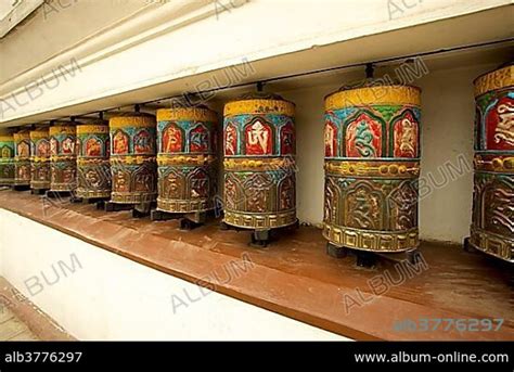 Buddhist prayer wheels on the exterior wall of the Swayambhunath Stupa ...