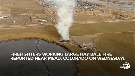 Firefighters Working At Scene Of Large Hay Bale Fire Near Mead