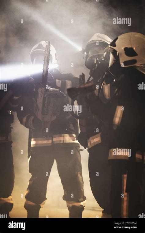 Group Of Professional Firefighters Wearing Full Equipment Oxygen Masks