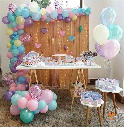 A Table Topped With Lots Of Balloons And Cake