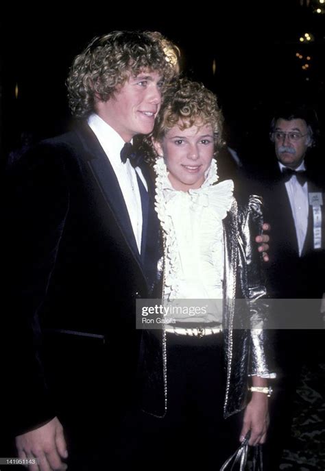 two people in tuxedos standing next to each other