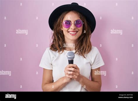 Beautiful Brunette Woman Singing Song Using Microphone Smiling With A Happy And Cool Smile On