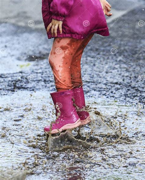 Child Outdoor Jump Into Puddle In Boot After Rain Stock Photo Image