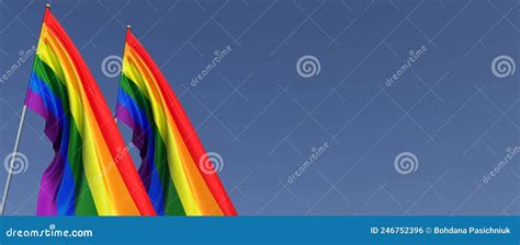 Two Lgbt Flags On A Flagpole On A Blue Background On The Side The