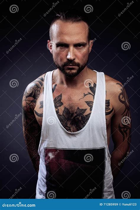 A Man With Tattooes On His Arms Silhouette Of Muscular Body Stock