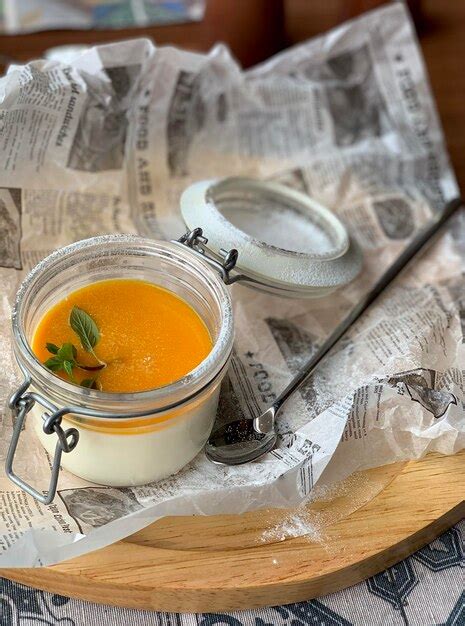 Premium Photo Vanilla Panna Cotta With Mango Puree In A Glass Jar