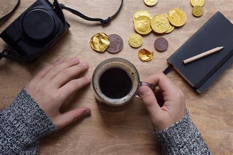 Premium Photo Midsection Of Person Holding Coffee Cup On Table