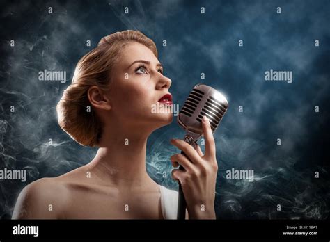 Beautiful Blonde Woman Singer With A Microphone Stock Photo Alamy