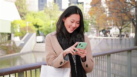 Serious Asian Business Young Woman Watiching In The Cell Phone App A