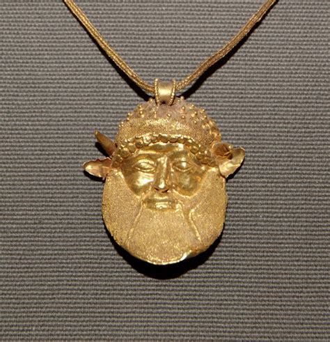 ANCIENT ART — Pendant with the head of the river god Achelous,...