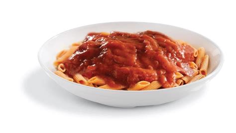 A White Bowl Filled With Pasta Covered In Marinara Sauce On Top Of A