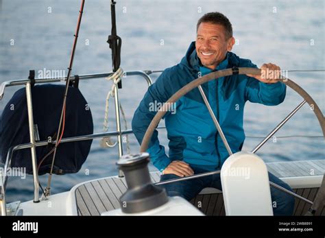 Smiling Mature Man Sailing A Ship Stock Photo Alamy