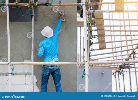 Plasterer in Blue Working Uniform Plastering the Wall of House Building ...