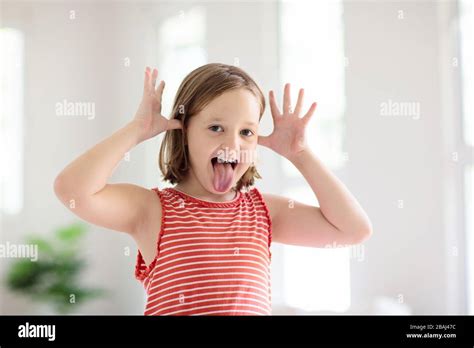 Child Making Funny Face Kid Teasing And Laughing Silly Little Girl