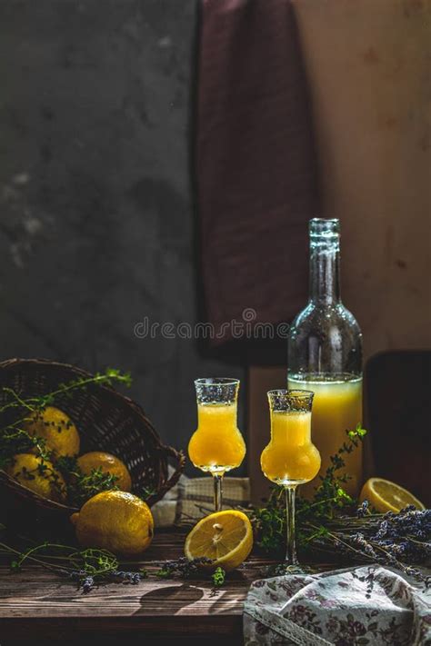 Limoncello In Grappas Wineglass With Water Drops And Lavender Artistic