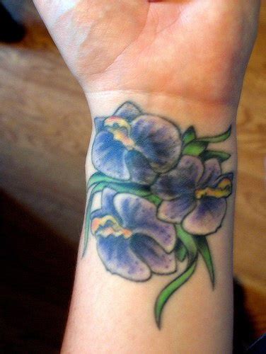 Blue orchid flowers tattoo on wrist - Tattooimages.biz