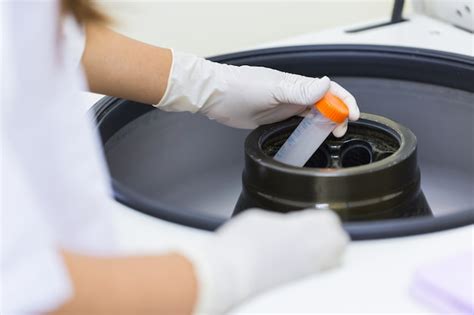 Premium Photo Scientist Putting Test Tube Into Centrifuge