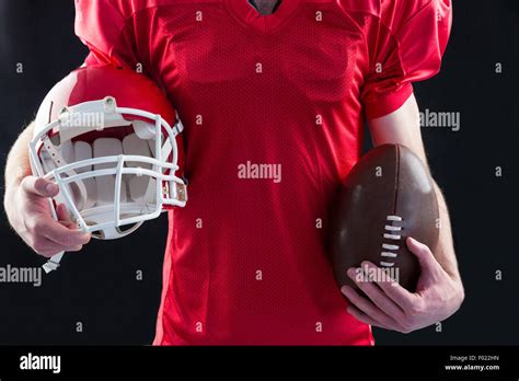 American Football Player Holding A Helmet And Ball Stock Photo Alamy