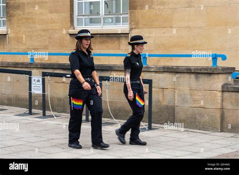 Two Female Police Officers Walking With Rainbow Lgbt Flags In There