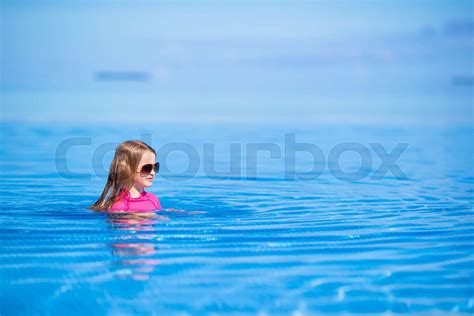 Smiling Adorable Girl Having Fun In Outdoor Swimming Pool Stock Image