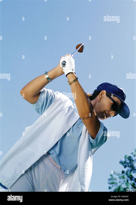 Mature golfer swinging Stock Photo - Alamy