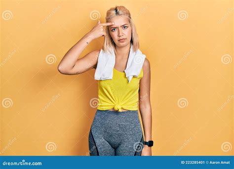 Beautiful Blonde Sports Woman Wearing Workout Outfit Pointing Unhappy