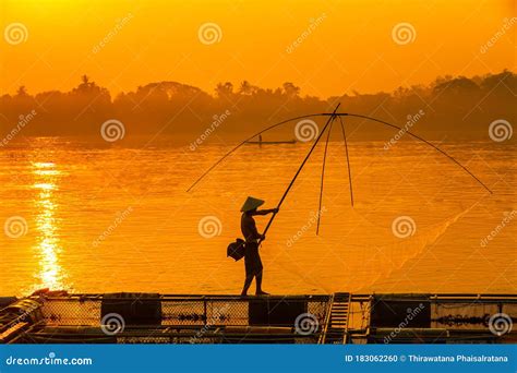 Asian Men Are Using Nets To Fish In The Mekong River Fishermen Raising