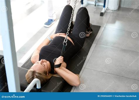 Beautiful Woman Is Exercising While Lying On Special Exercise Machine