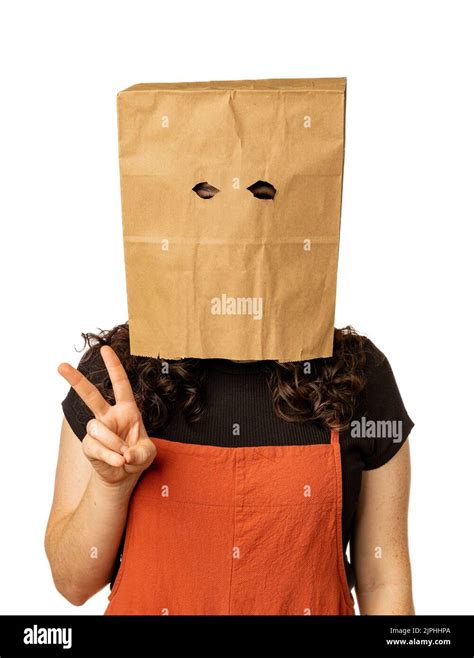 Woman Wearing Paper Bag Over Her Head And Giving The Peace Sign Stock