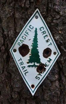 A Sign That Is On The Side Of A Tree