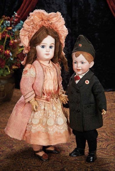 Two Dolls Are Standing Next To Each Other