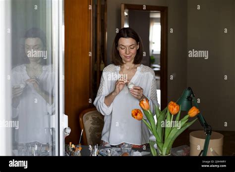 Smiling Mature Woman Sculpting Dolls Face At Table Stock Photo Alamy
