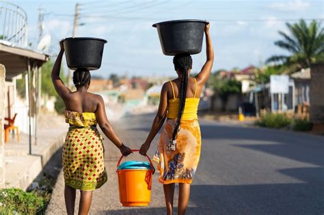 Premium Photo Beautiful African Women Fetching Water From Outdoors