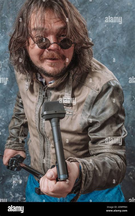Mature Rocker With Microphone Emotional Studio Portrait Stock Photo Alamy
