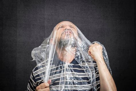 Premium Photo Mature Man With A Transparent Plastic Bag Flying Over