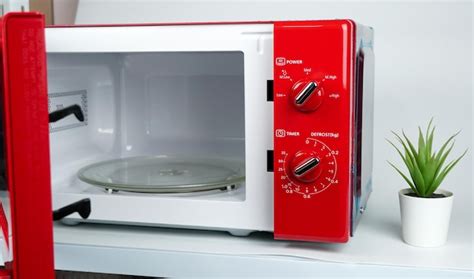 Premium Photo An Open Red Microwave Placed On The Table