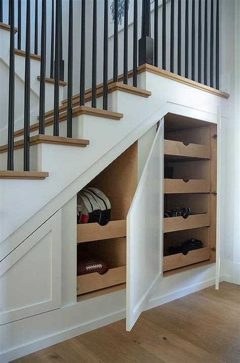 A Modern Staircase Features Built In Hidden Cabinets With Stacked Pull