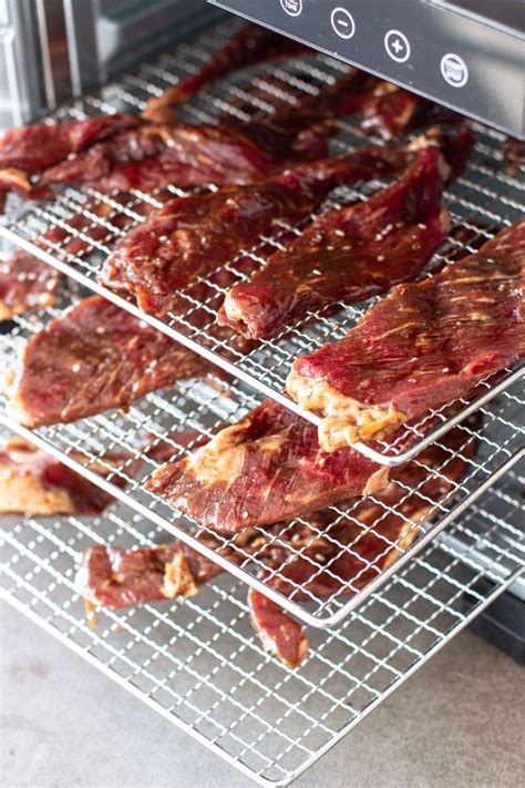 Some Meat Is Cooling On A Rack In The Oven