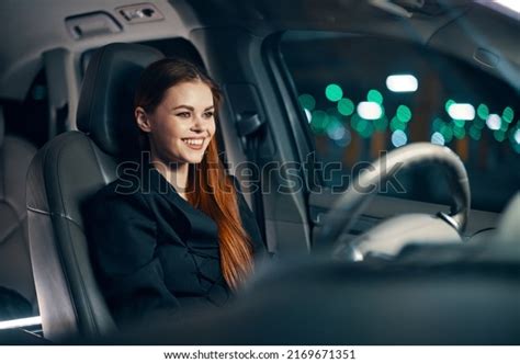 A Happy Relaxed Woman Enjoys A Night Drive While Sitting In A Car Stock Image Everypixel