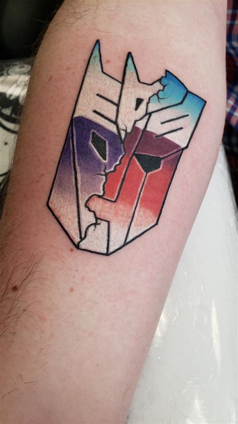 My first tattoo - a cracked Autobot / Deception symbol : r/transformers