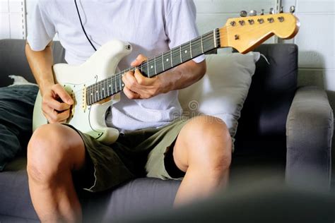 Man Playing Electrical Guitar On Sofa At Home Stock Image Image Of